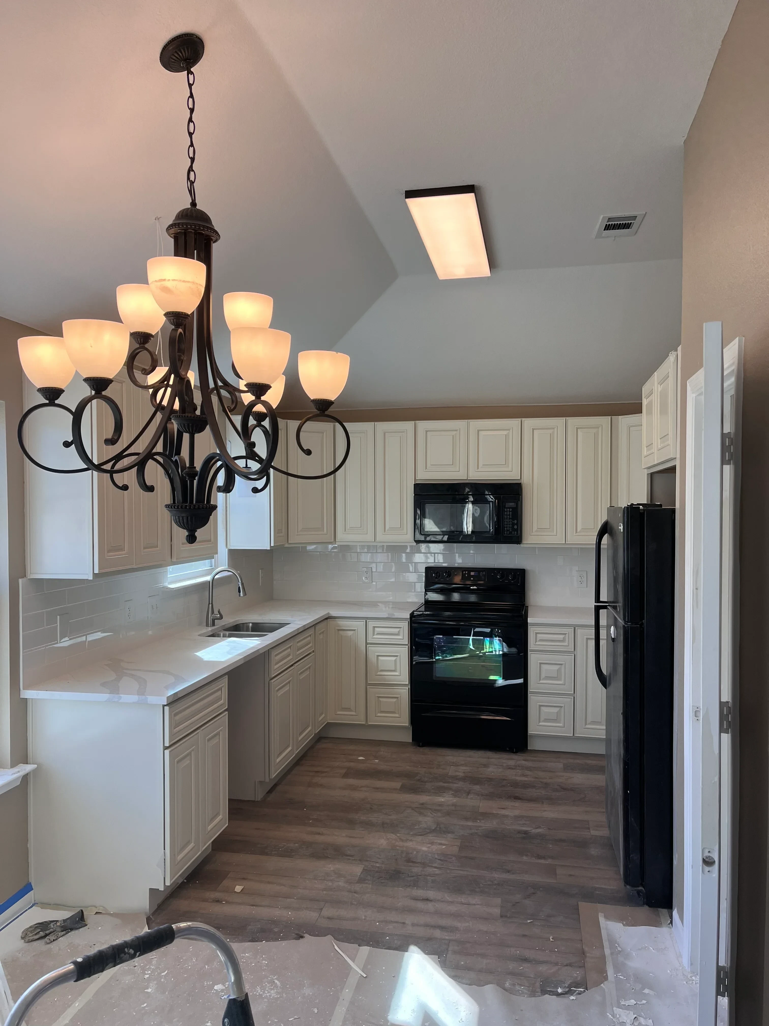 RV interior with restored cabinetry, new flooring, and installed lighting fixtures