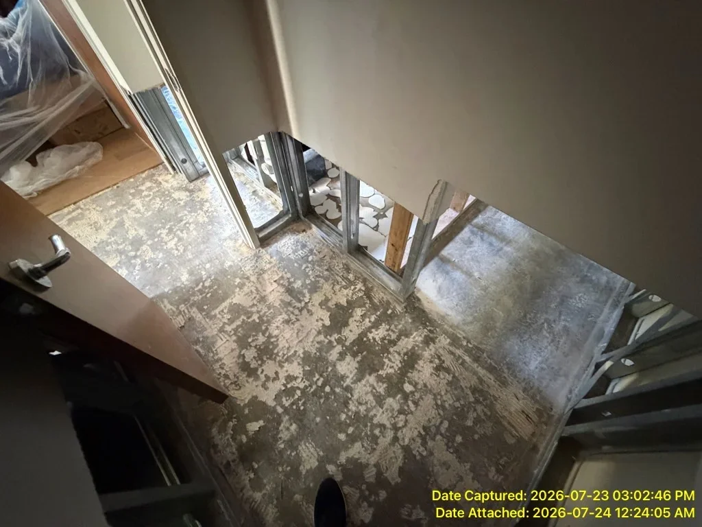 Water-damaged concrete floor with drying equipment and dehumidifiers in place